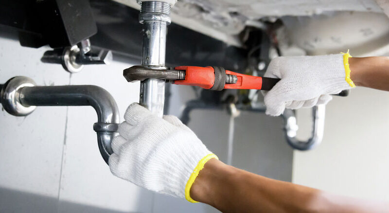 close up on a sink pipe being worked on